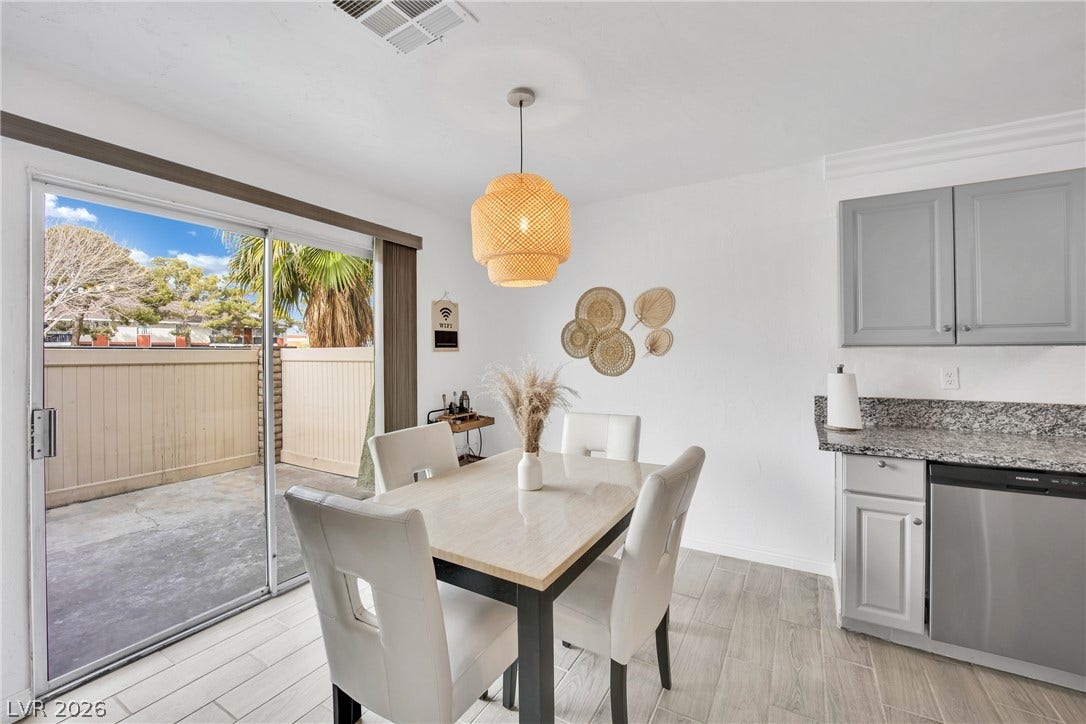 Crown molding and tiled floors frame this inviting dining area adjacent to the kitchen.