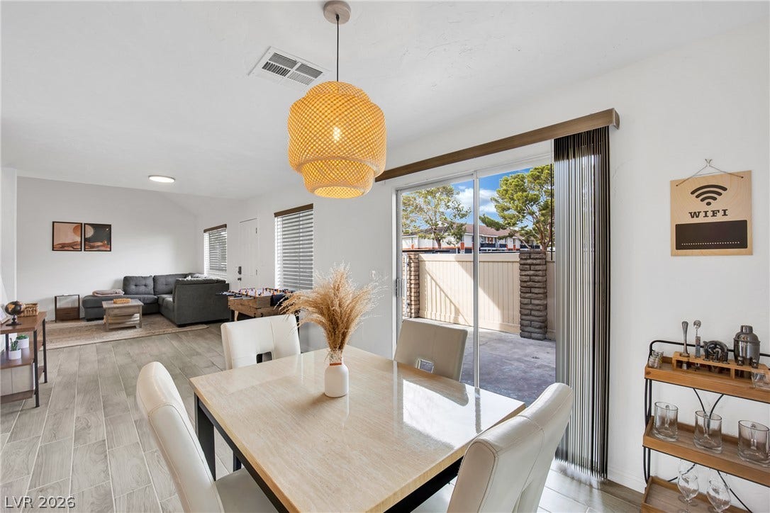 Sliding glass doors open from the dining area directly onto a private back patio.