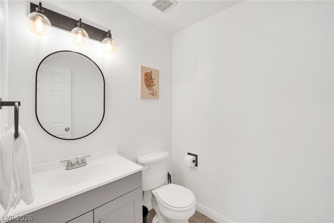 Clean lines and modern fixtures define this light-filled powder room.