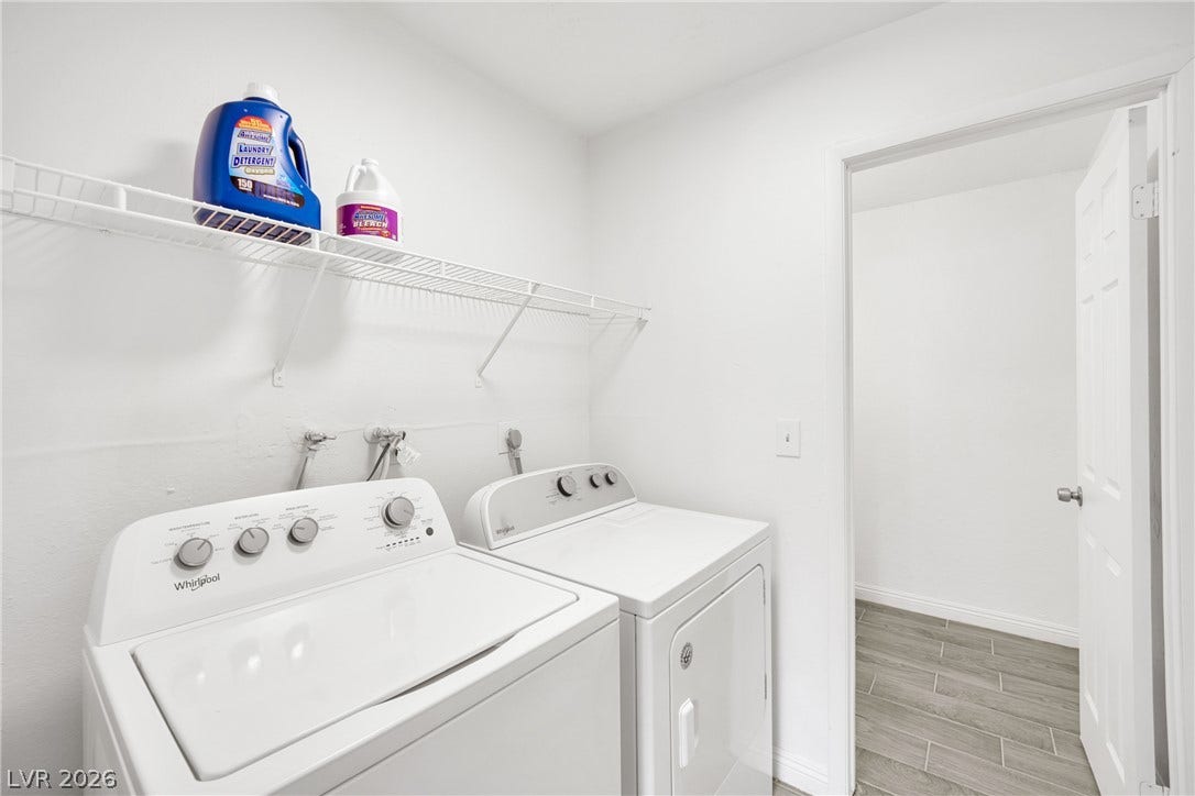 Functional utility space includes built-in wire shelving and durable modern tile flooring.