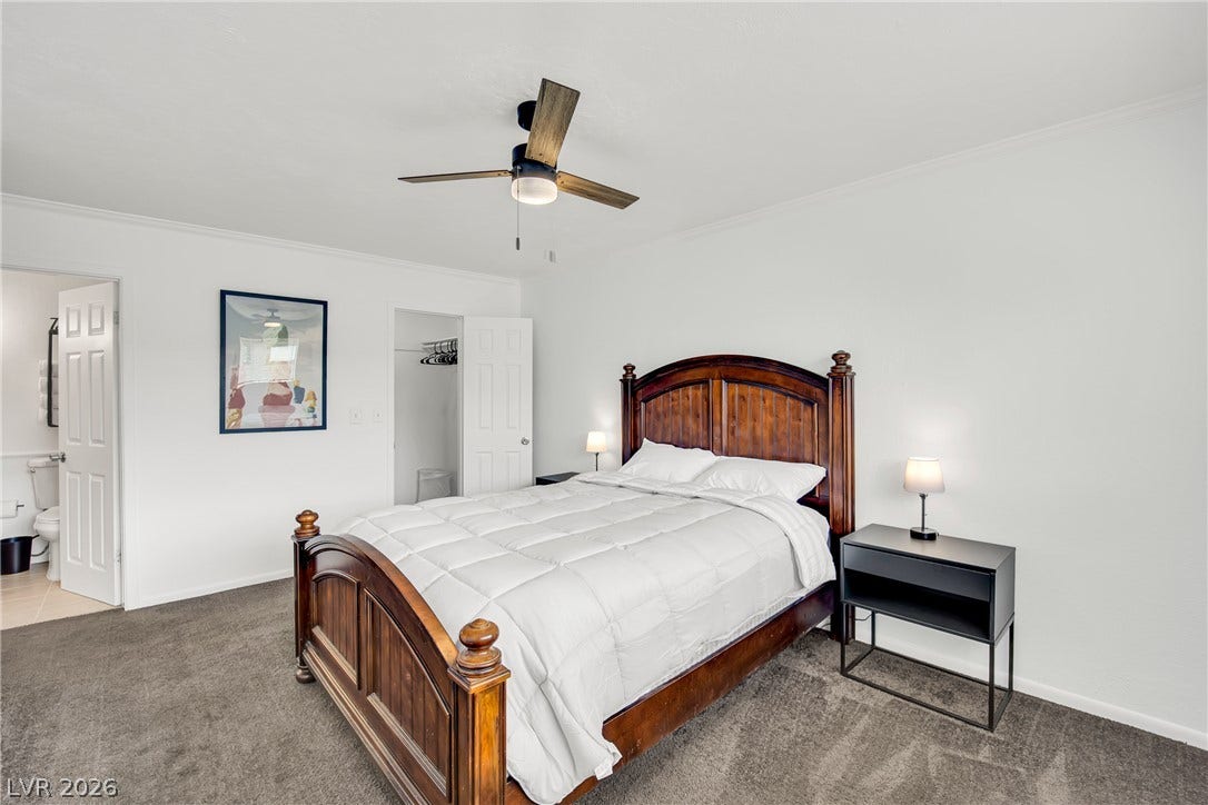 A quiet retreat featuring plush carpeting and a private adjoining bathroom.