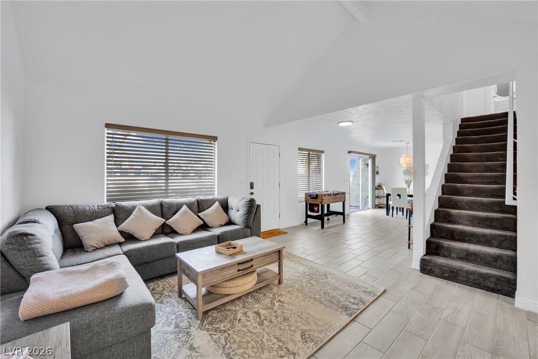 Vaulted ceilings and tile flooring enhance this open-concept main living area.
