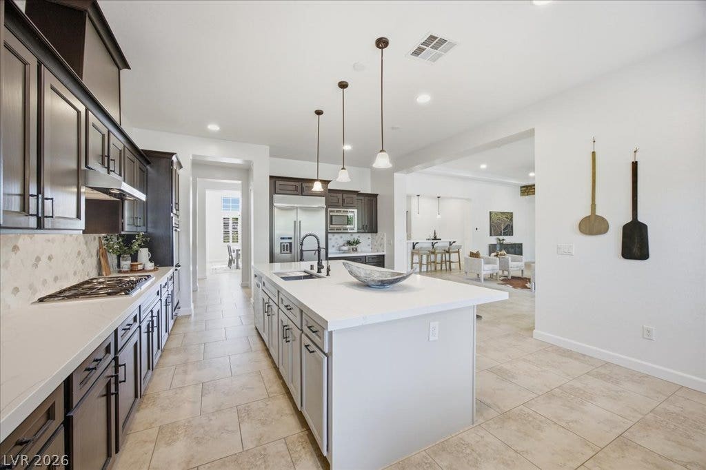 8030 Palm Cove Court, Las Vegas, NV 89129 Granite counters and tiled floors highlight this modern culinary space.