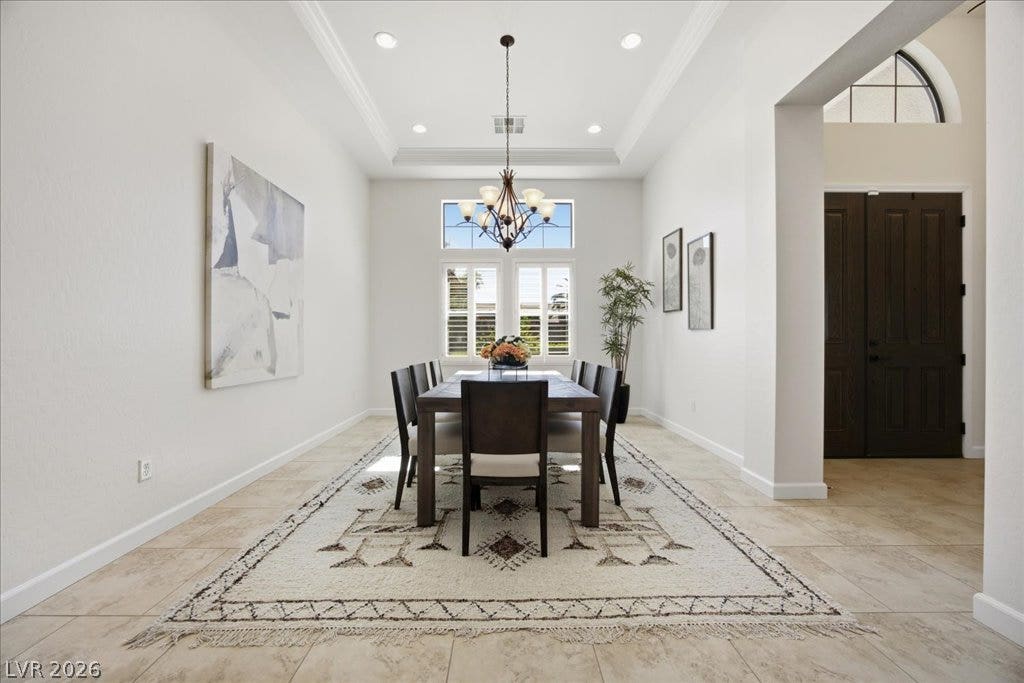8030 Palm Cove Court, Las Vegas, NV 89129 A tray ceiling and tile flooring define this elegant, open-concept dining space.