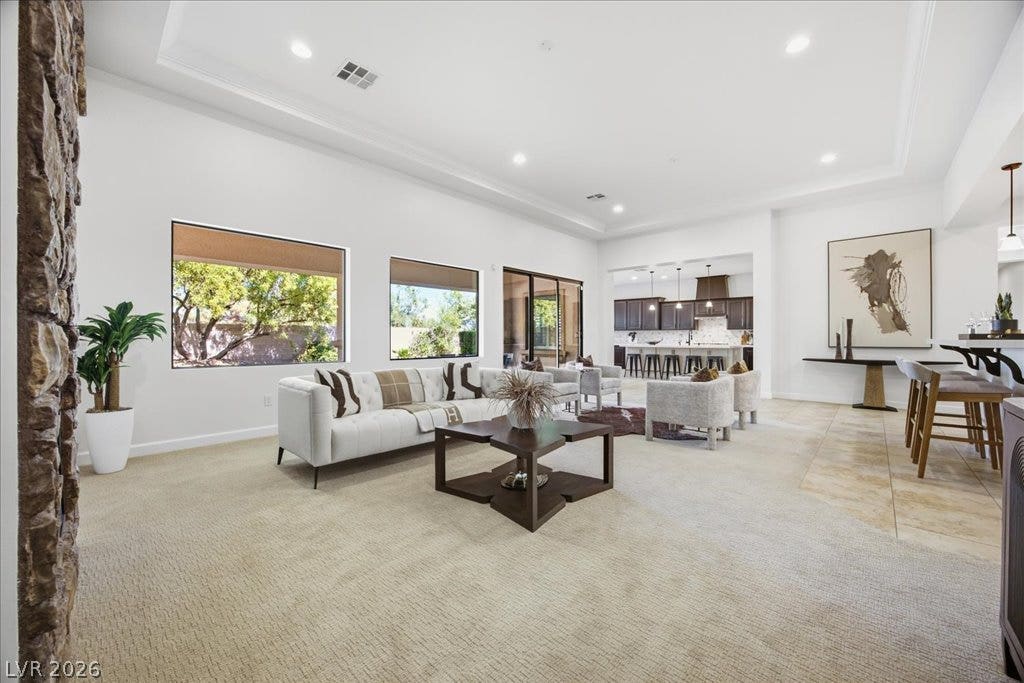 8030 Palm Cove Court, Las Vegas, NV 89129 An open floorplan design seamlessly connects the main living spaces over mixed flooring surfaces.