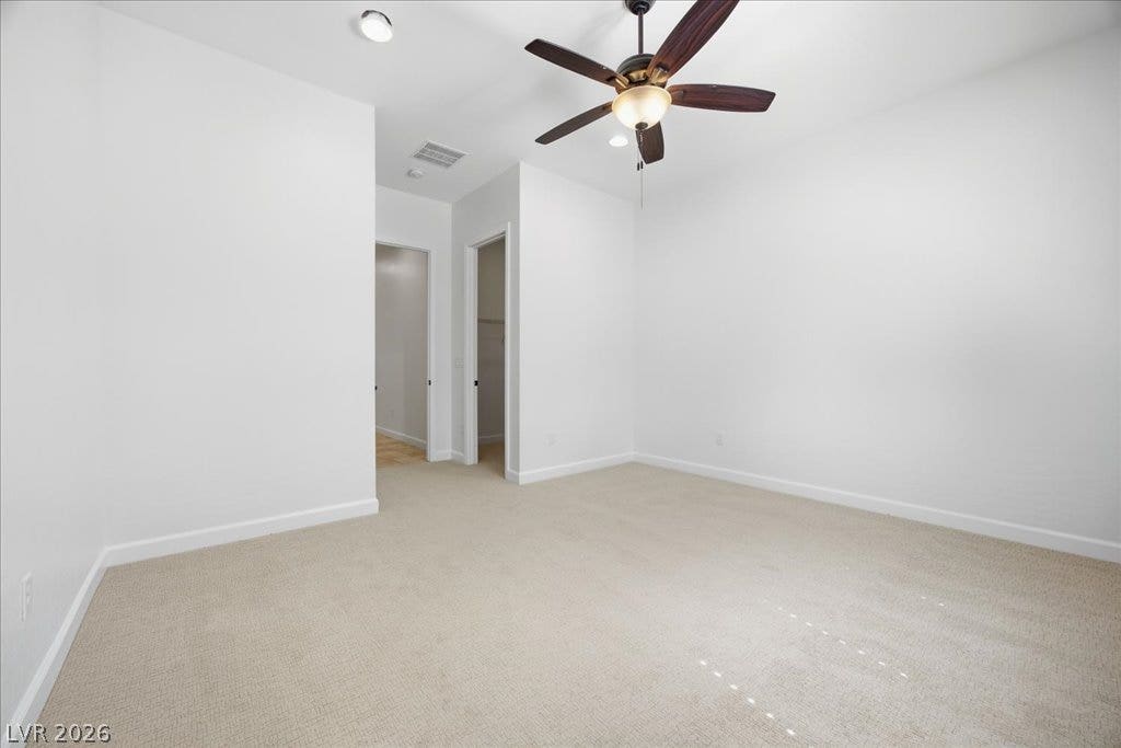 8030 Palm Cove Court, Las Vegas, NV 89129 Soft carpeting pairs with neutral walls in this versatile bedroom space.