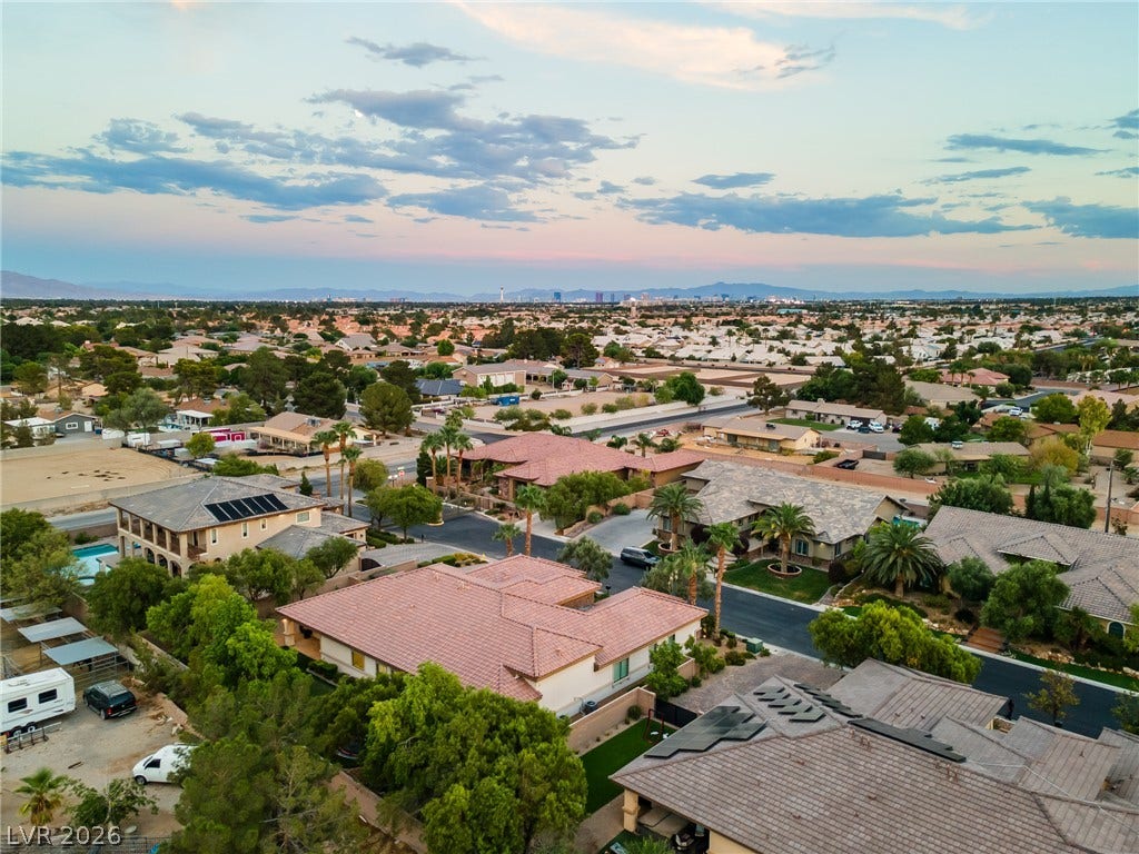 8030 Palm Cove Court, Las Vegas, NV 89129 Panoramic mountain and skyline views overlook this sprawling residential neighborhood under soft twilight skies.