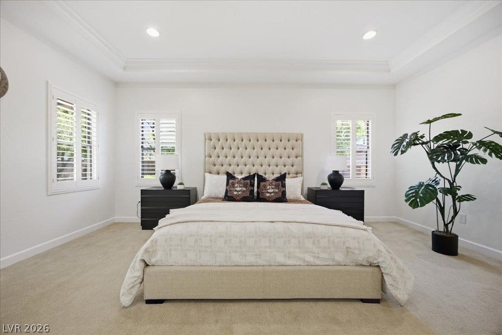 8030 Palm Cove Court, Las Vegas, NV 89129 Crown molding highlights the tray ceiling in this carpeted main suite with plantation shutters.