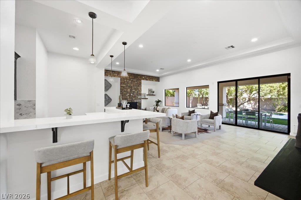 8030 Palm Cove Court, Las Vegas, NV 89129 Gleaming tile floors and soaring ceilings elevate this expansive open-concept living area.
