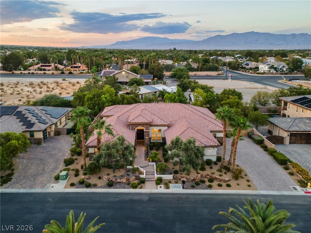 8030 Palm Cove Court, Las Vegas, NV 89129 Striking desert mountains frame this elegant tile-roofed residence and its manicured grounds.