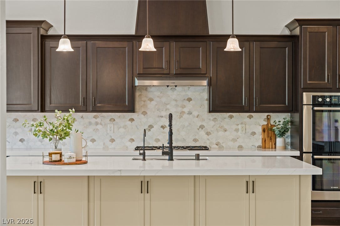 8030 Palm Cove Court, Las Vegas, NV 89129 Gleaming stone countertops and custom cabinetry define this modern culinary space.