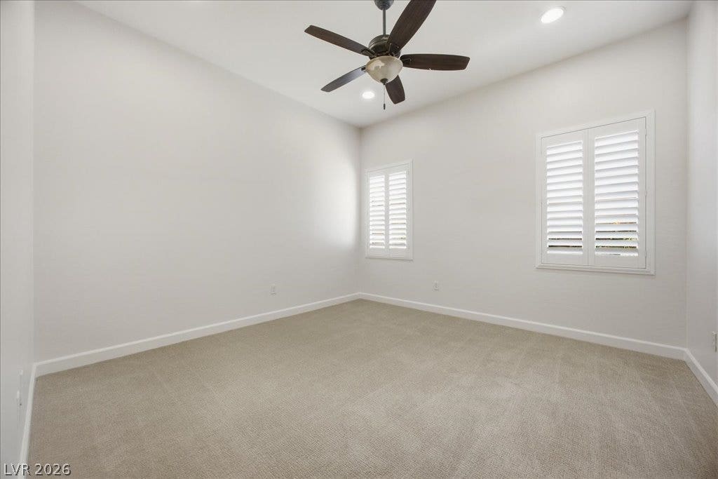 8030 Palm Cove Court, Las Vegas, NV 89129 Bedroom 3: Plush carpeting and elegant plantation shutters define this versatile secondary bedroom space.