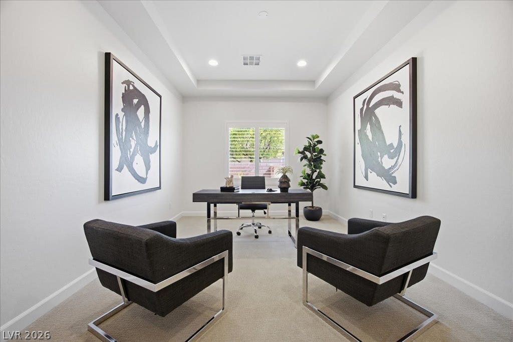 8030 Palm Cove Court, Las Vegas, NV 89129 An elegant tray ceiling and plush carpeting define this quiet home workspace.