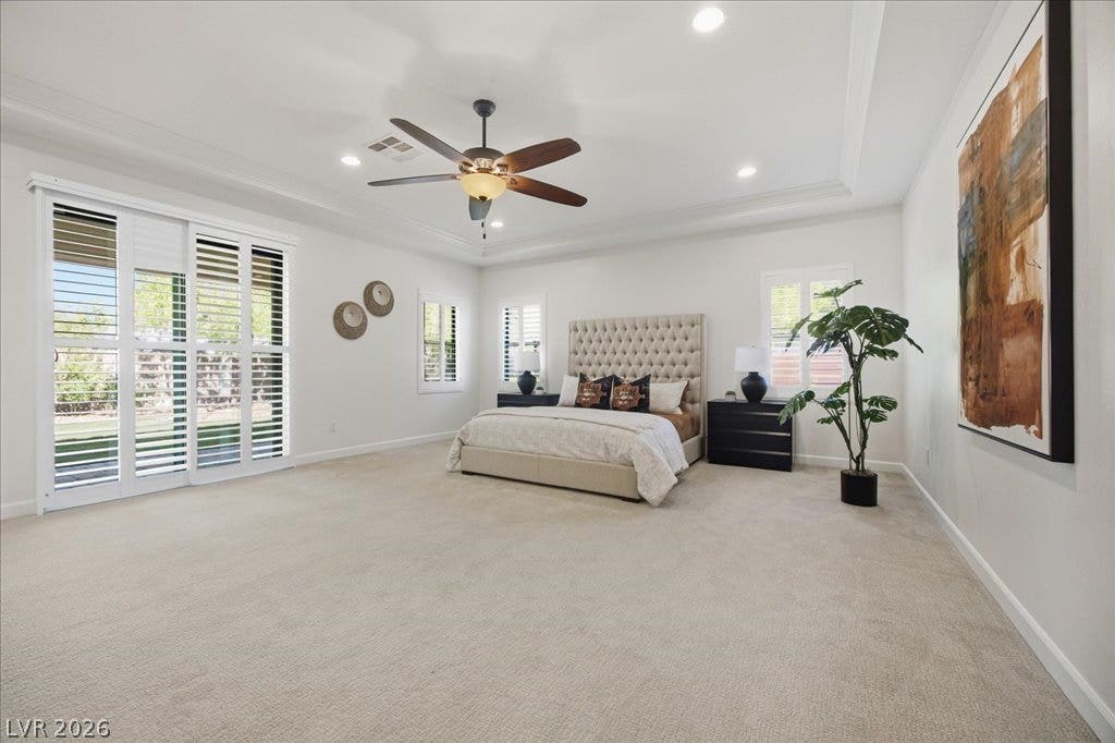 8030 Palm Cove Court, Las Vegas, NV 89129 Plentiful natural light streams through wide plantation shutters in this airy primary bedroom retreat.