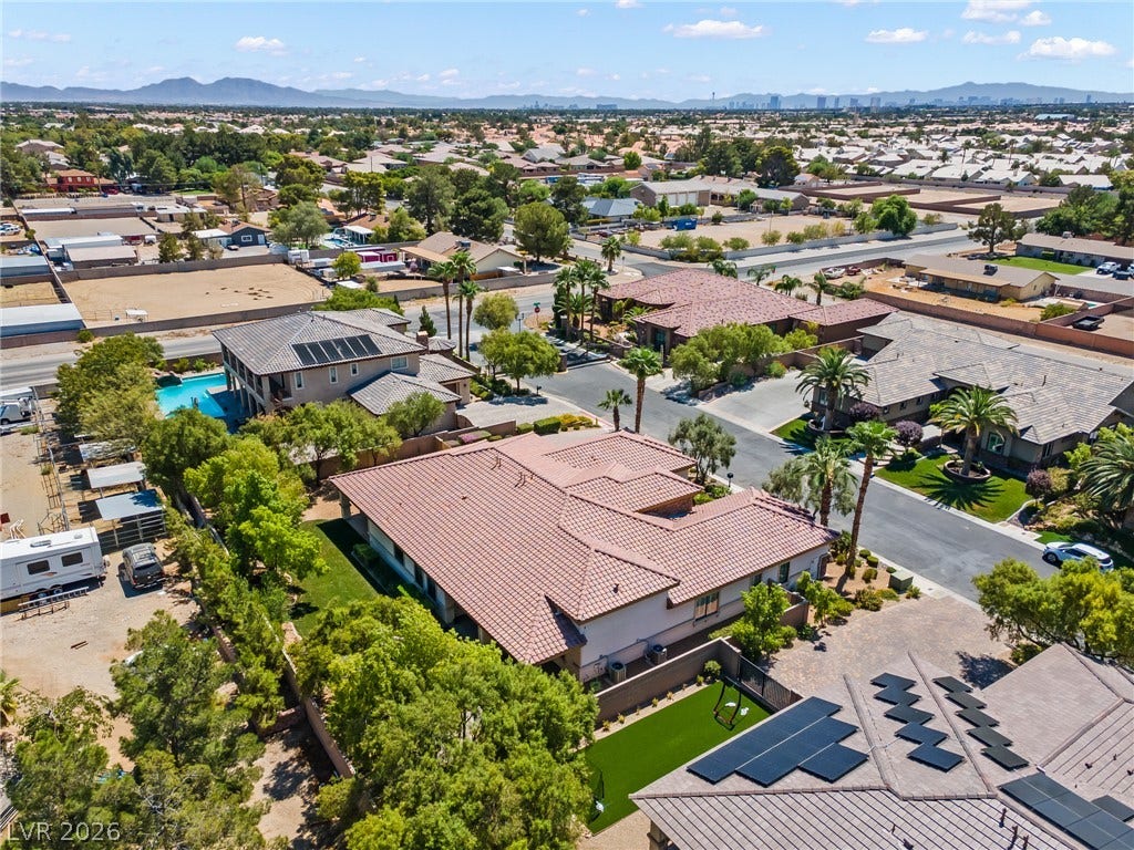 8030 Palm Cove Court, Las Vegas, NV 89129 An aerial perspective reveals tile roofs and manicured yards in a peaceful neighborhood setting.