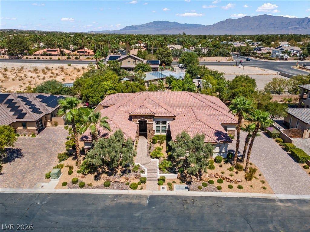 8030 Palm Cove Court, Las Vegas, NV 89129 A terracotta tile roof and mature palm trees define this desert estate under mountain vistas.