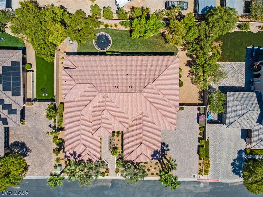 8030 Palm Cove Court, Las Vegas, NV 89129 An aerial perspective showcases the tiled rooflines and landscaped surroundings of this expansive property.