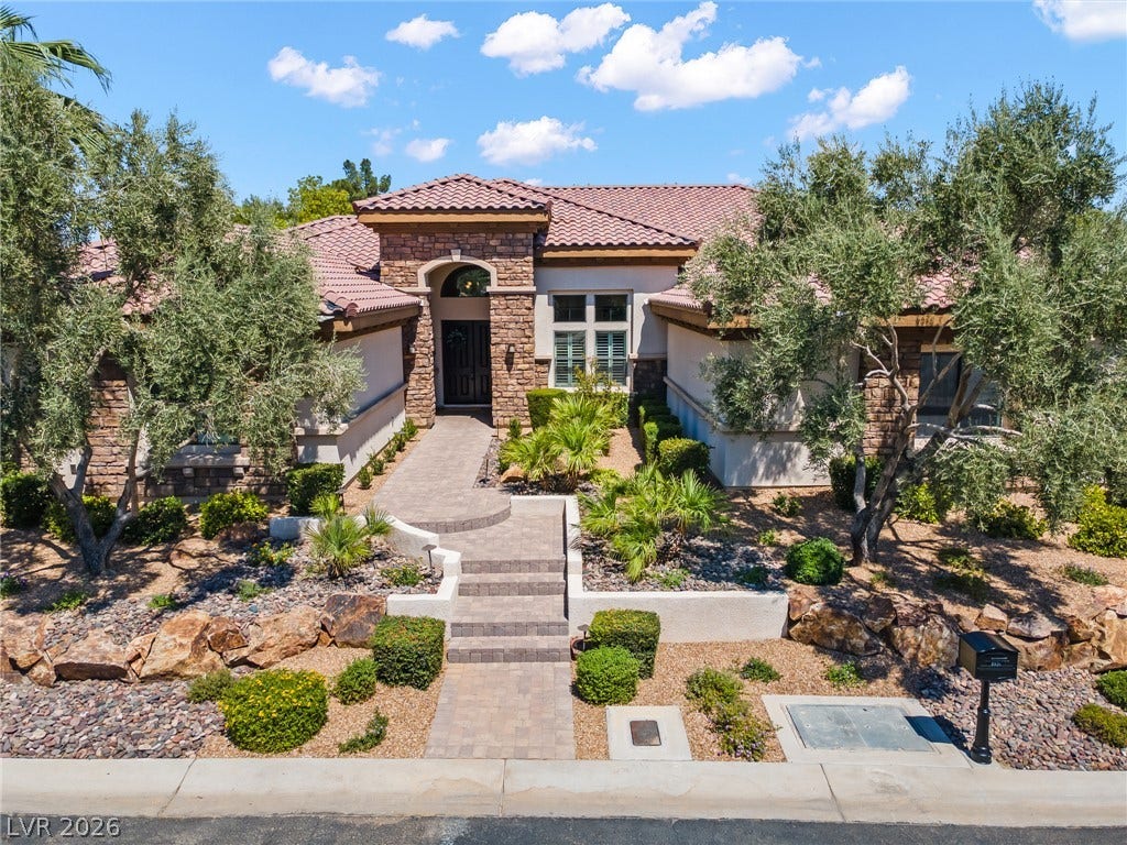 8030 Palm Cove Court, Las Vegas, NV 89129 Artfully arranged stone details and native landscaping frame a welcoming paved path to the entrance.