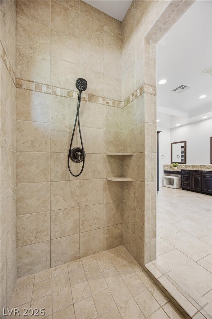 8030 Palm Cove Court, Las Vegas, NV 89129 Earth-toned tiles line the walls and floor of this walk-in shower.