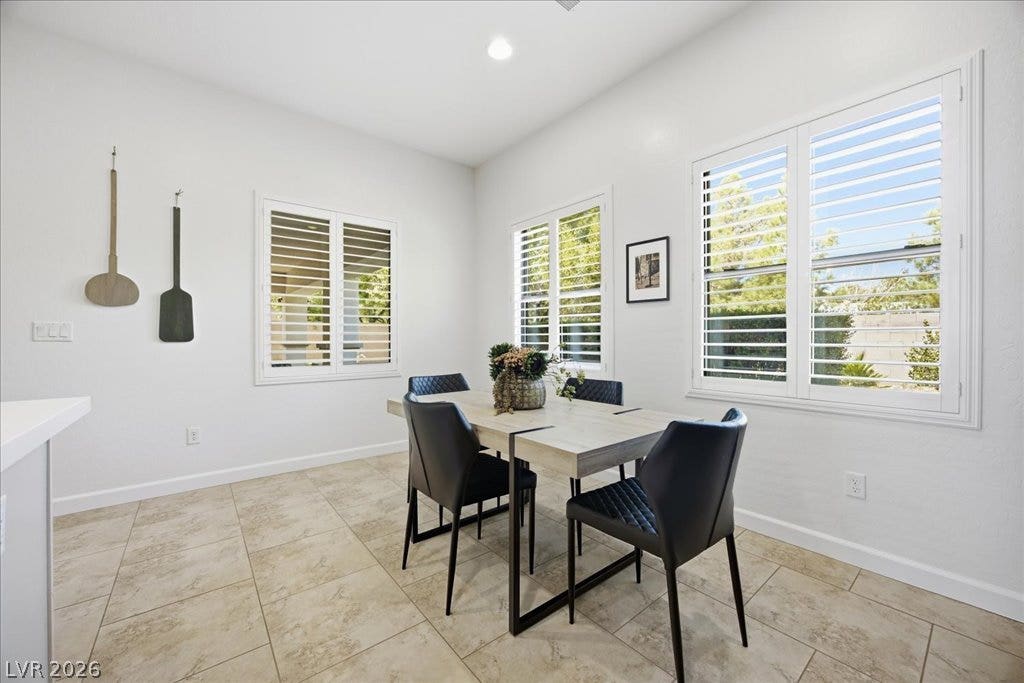 8030 Palm Cove Court, Las Vegas, NV 89129 Sunlight streams through plantation shutters to illuminate tile flooring in this inviting dining area.