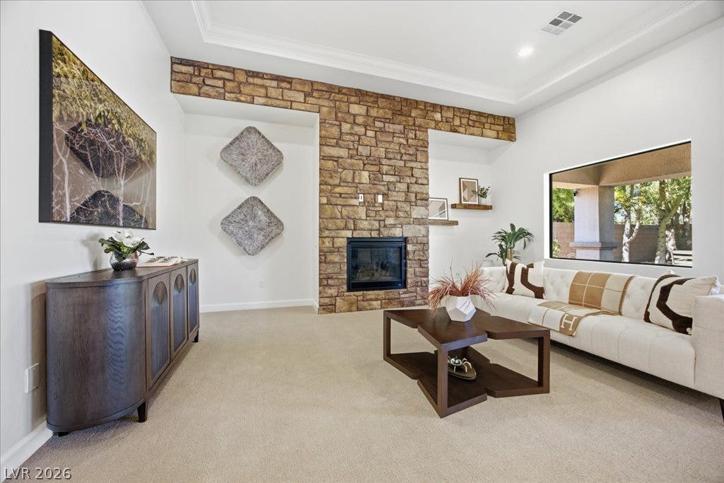 8030 Palm Cove Court, Las Vegas, NV 89129 An impressive floor-to-ceiling stone fireplace serves as the centerpiece of this bright living room.