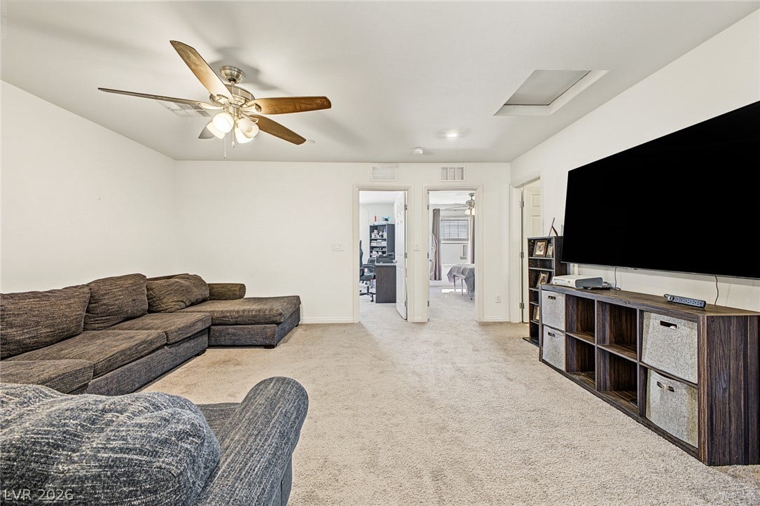 1180 Gypsum Hills Court, Henderson, NV 89002 Carpeted floors and clean walls anchor this flexible secondary living area.