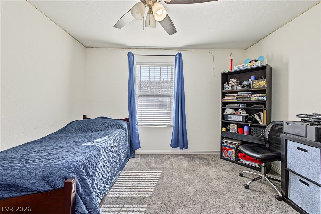 1180 Gypsum Hills Court, Henderson, NV 89002 Soft carpet underfoot paired with natural window light anchors this classic secondary bedroom.