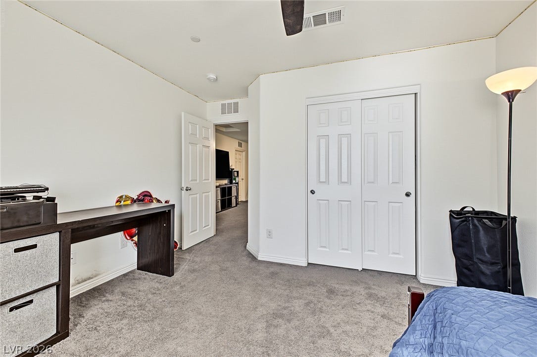 1180 Gypsum Hills Court, Henderson, NV 89002 Plush wall-to-wall carpeting and clean plaster walls define this versatile secondary bedroom space.