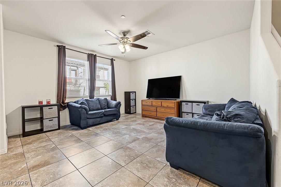 1180 Gypsum Hills Court, Henderson, NV 89002 Durable tile flooring spans this versatile living space filled with natural light.