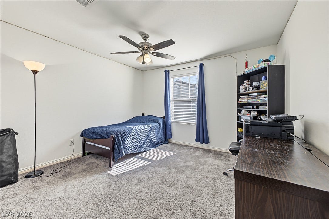 1180 Gypsum Hills Court, Henderson, NV 89002 Plush carpeting and a classic window setup define this versatile secondary bedroom space.