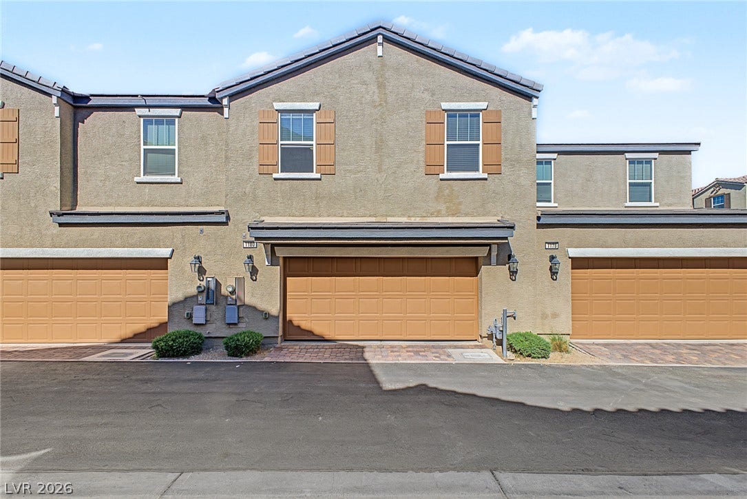 1180 Gypsum Hills Court, Henderson, NV 89002 Earth-toned stucco siding and decorative shutters accent the classic exterior of this multi-level townhouse.
