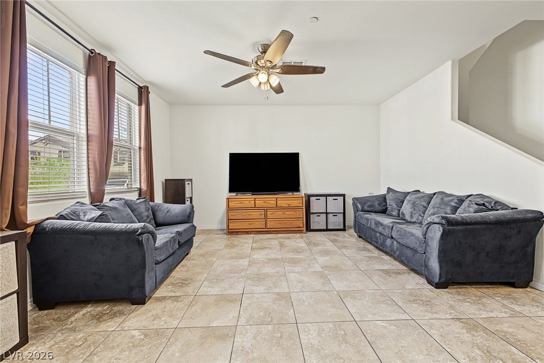 1180 Gypsum Hills Court, Henderson, NV 89002 Tiled flooring and large windows create a spacious feel in this living area.