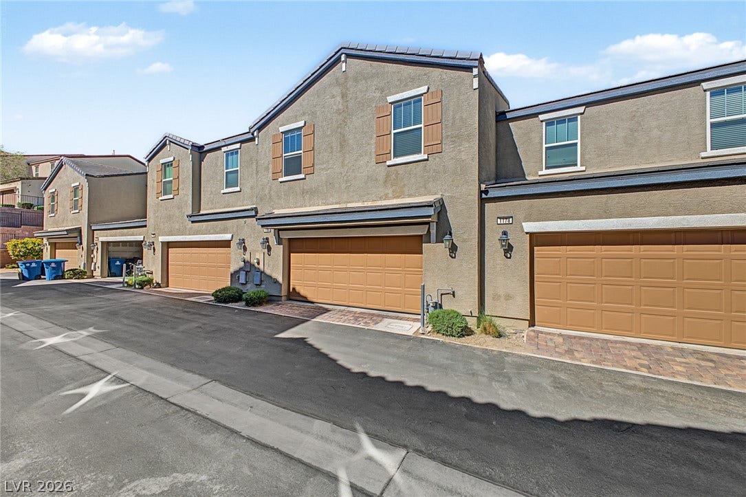 1180 Gypsum Hills Court, Henderson, NV 89002 Stucco exteriors paired with multiple multi-car garages line this clean private driveway.