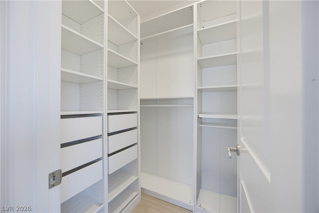 446 Bosco Di Fiore Street, Las Vegas, NV 89138 Custom built-in shelving and ample hanging space define this functional walk-in closet.