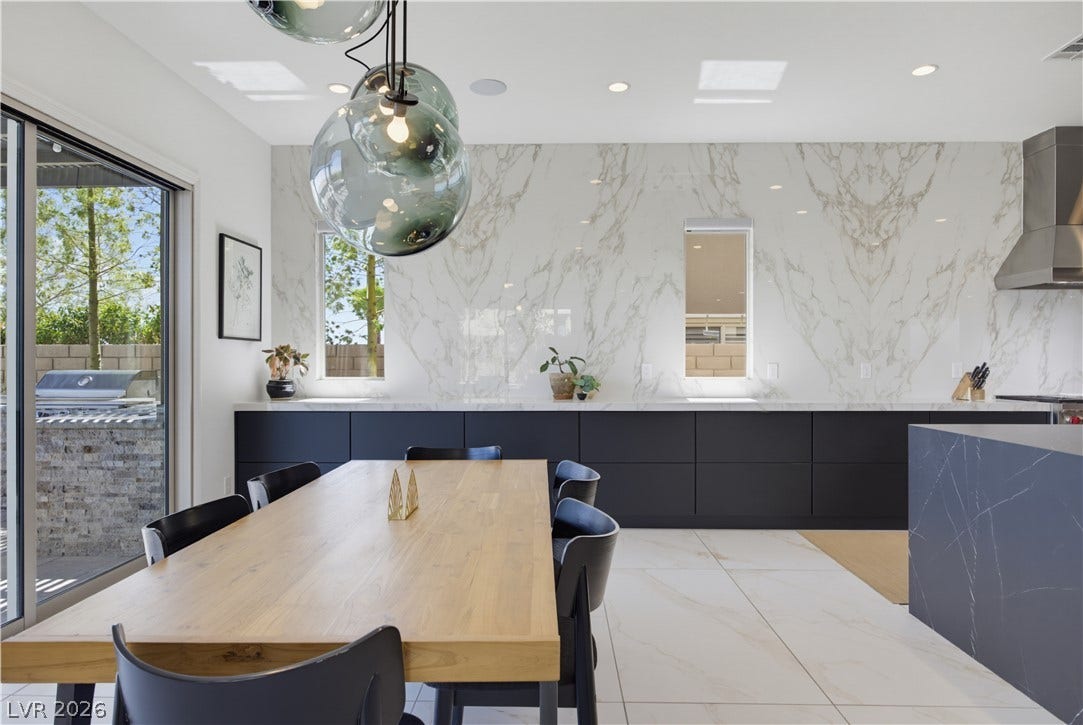446 Bosco Di Fiore Street, Las Vegas, NV 89138 Sleek modern cabinetry and bookmatched stone walls define this elegant open culinary space.