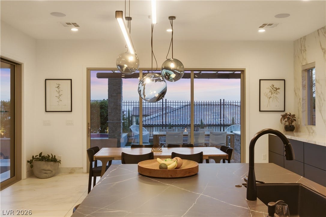 446 Bosco Di Fiore Street, Las Vegas, NV 89138 Glass sliding doors open from this modern interior to a spacious covered outdoor terrace.