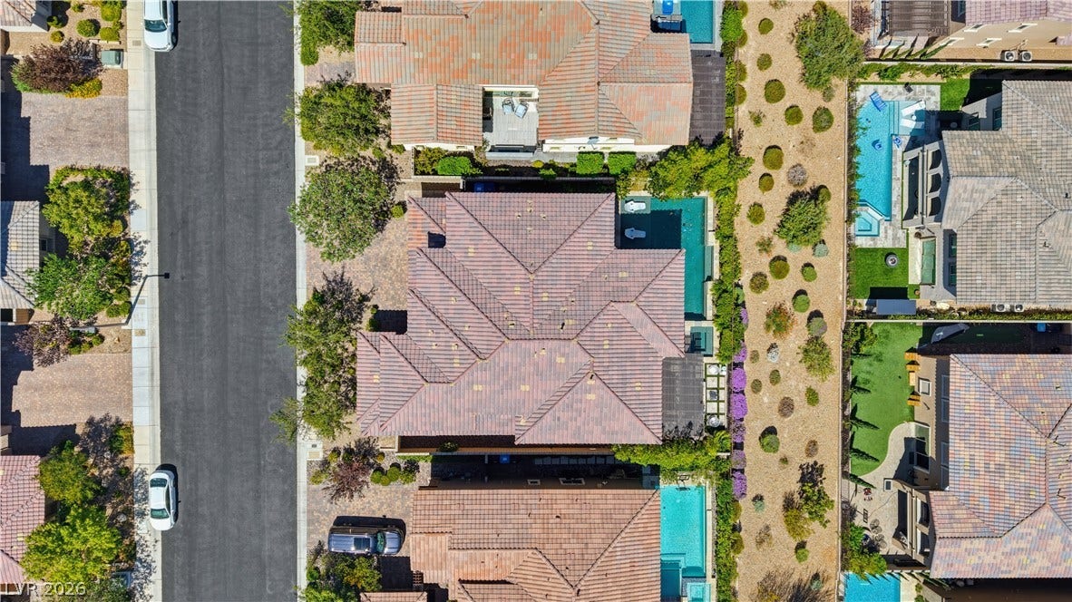 446 Bosco Di Fiore Street, Las Vegas, NV 89138 An aerial perspective showcases the tiled rooftops and private pools of this suburban neighborhood.