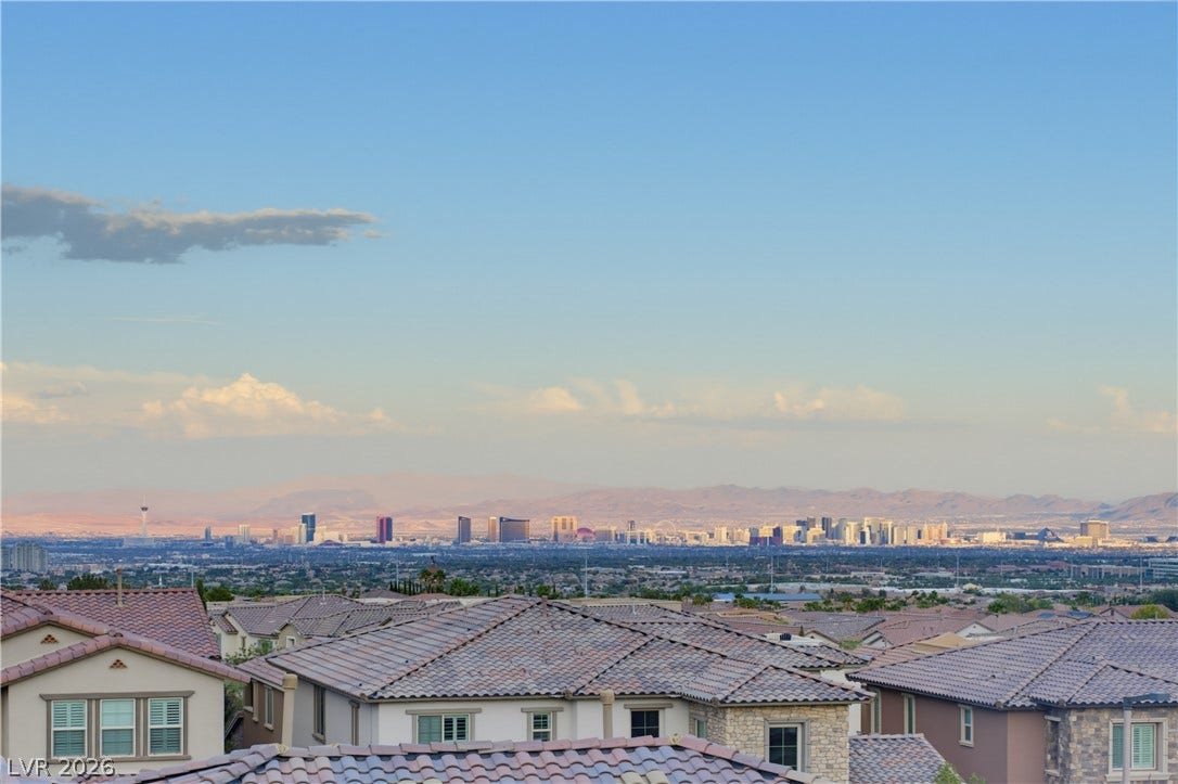 446 Bosco Di Fiore Street, Las Vegas, NV 89138 Panoramas of the distant city skyline stretch beyond the tiled rooftops.