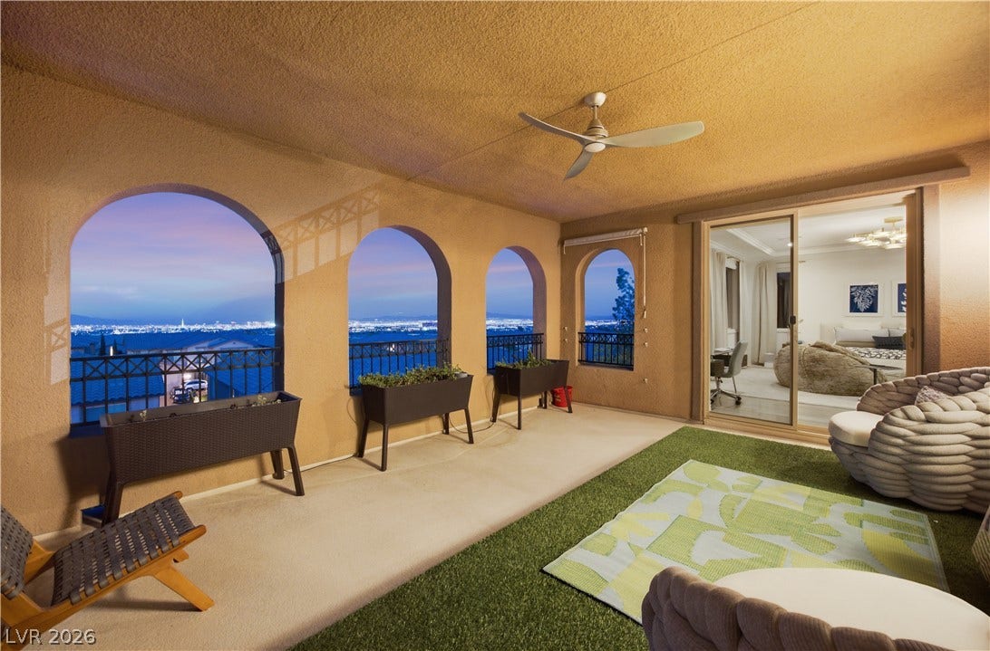 446 Bosco Di Fiore Street, Las Vegas, NV 89138 Arched openings frame far-reaching city light views from this covered patio space.