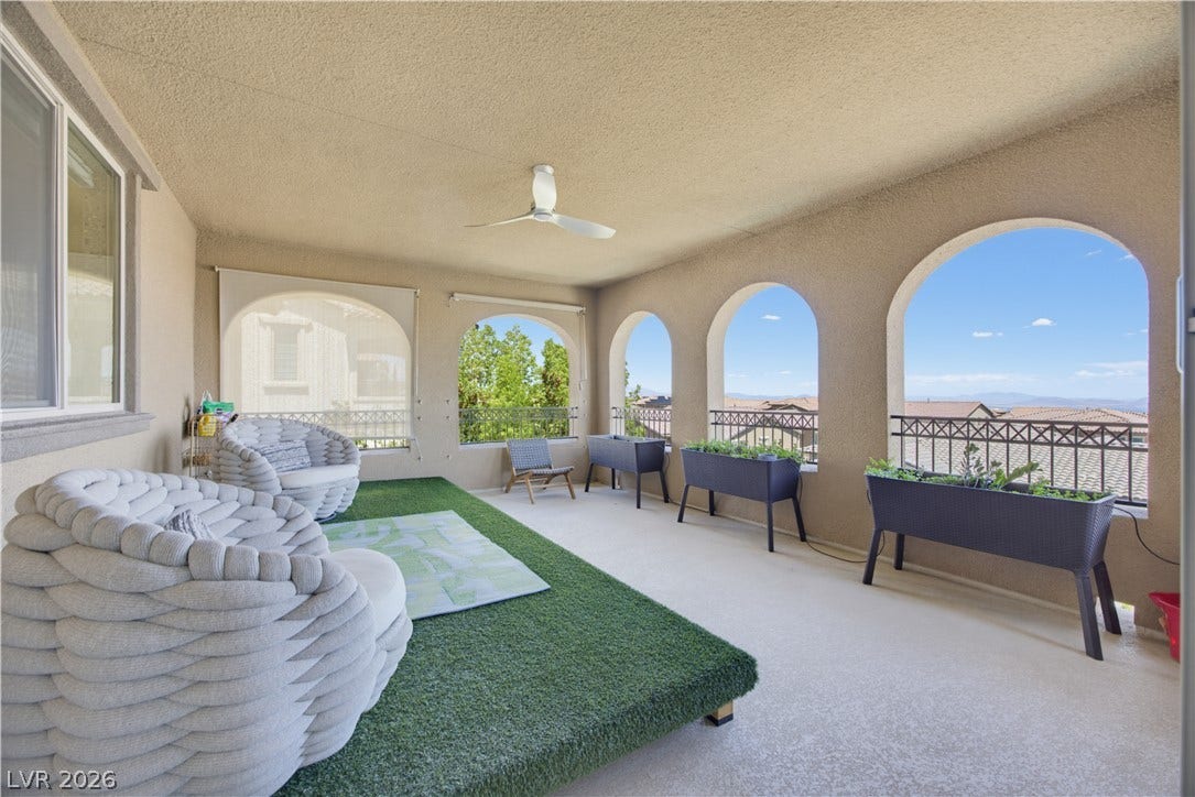 446 Bosco Di Fiore Street, Las Vegas, NV 89138 Arched openings frame far-reaching neighborhood vistas from this sheltered outdoor terrace.