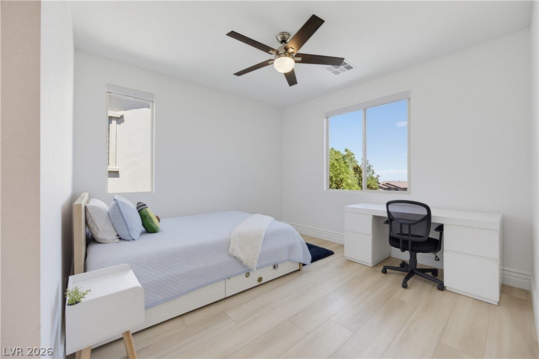 446 Bosco Di Fiore Street, Las Vegas, NV 89138 Crisp white walls and light hardwood floors create a peaceful, light-filled bedroom retreat.
