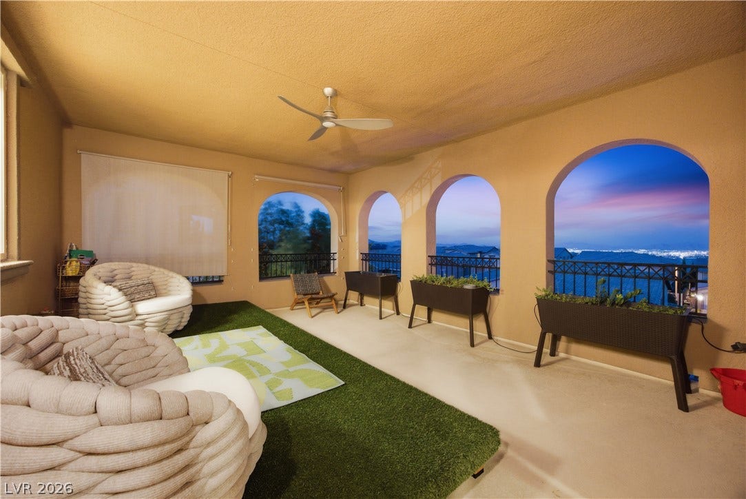 446 Bosco Di Fiore Street, Las Vegas, NV 89138 Arched openings frame panoramic evening city light views from this covered outdoor terrace.
