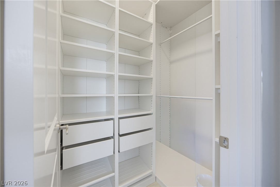 446 Bosco Di Fiore Street, Las Vegas, NV 89138 Custom shelving and integrated drawers maximize storage in this spacious walk-in closet.