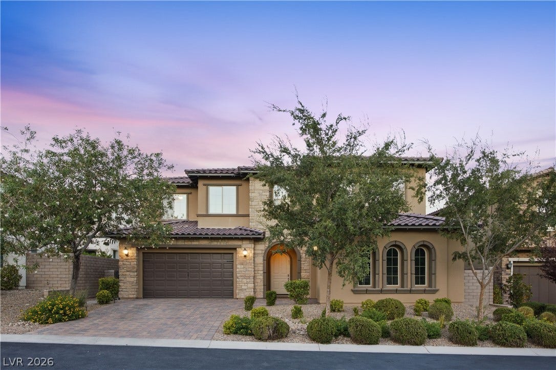 446 Bosco Di Fiore Street, Las Vegas, NV 89138 Elegant stone accents and arched windows define this multi-level home under a twilight sky.