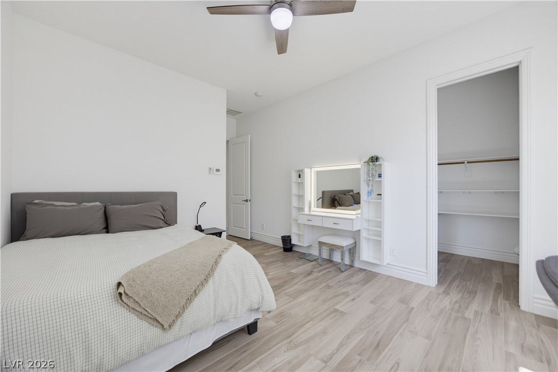 446 Bosco Di Fiore Street, Las Vegas, NV 89138 Downstairs bedroom with gleaming light wood floors and clean white walls define this airy bedroom suite.