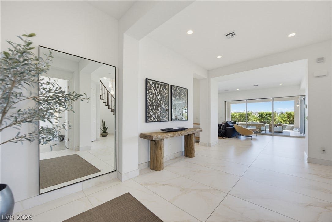 446 Bosco Di Fiore Street, Las Vegas, NV 89138 Polished tile flooring and recessed lighting define this open entry hall.