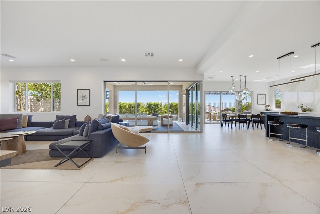 446 Bosco Di Fiore Street, Las Vegas, NV 89138 Gleaming tile floors stretch across a seamless layout connected to the outdoors by sliding glass doors.