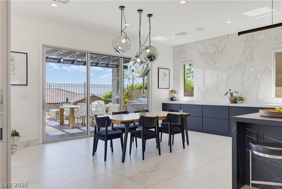 446 Bosco Di Fiore Street, Las Vegas, NV 89138 Gleaming tile floors and sliding glass doors enhance this open dining and kitchen area.