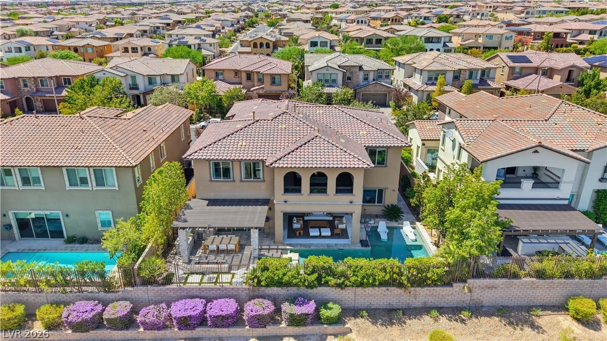 446 Bosco Di Fiore Street, Las Vegas, NV 89138 An aerial view showcases this two-story residence highlighting a tile roof and a private pool.