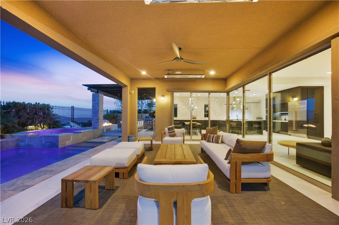 446 Bosco Di Fiore Street, Las Vegas, NV 89138 Sliding glass walls open to integrate indoor living with a sheltered poolside terrace.